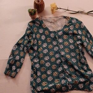 Aqua and yellow top with white and black dots.